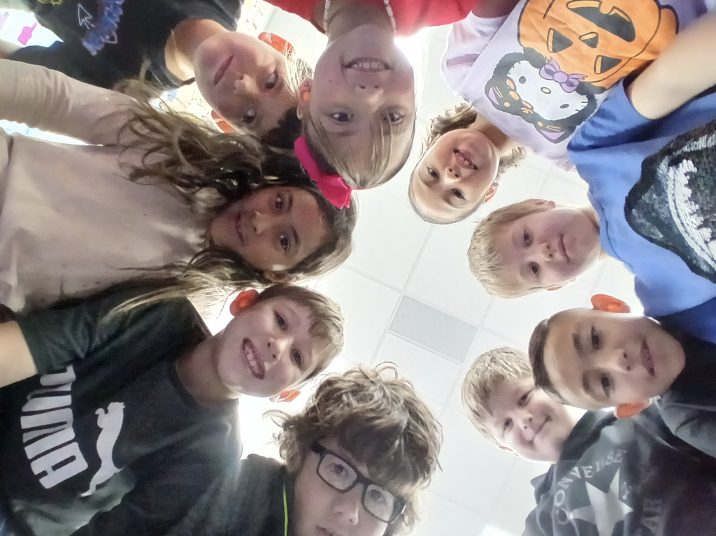 students together in a group with smiling faces.