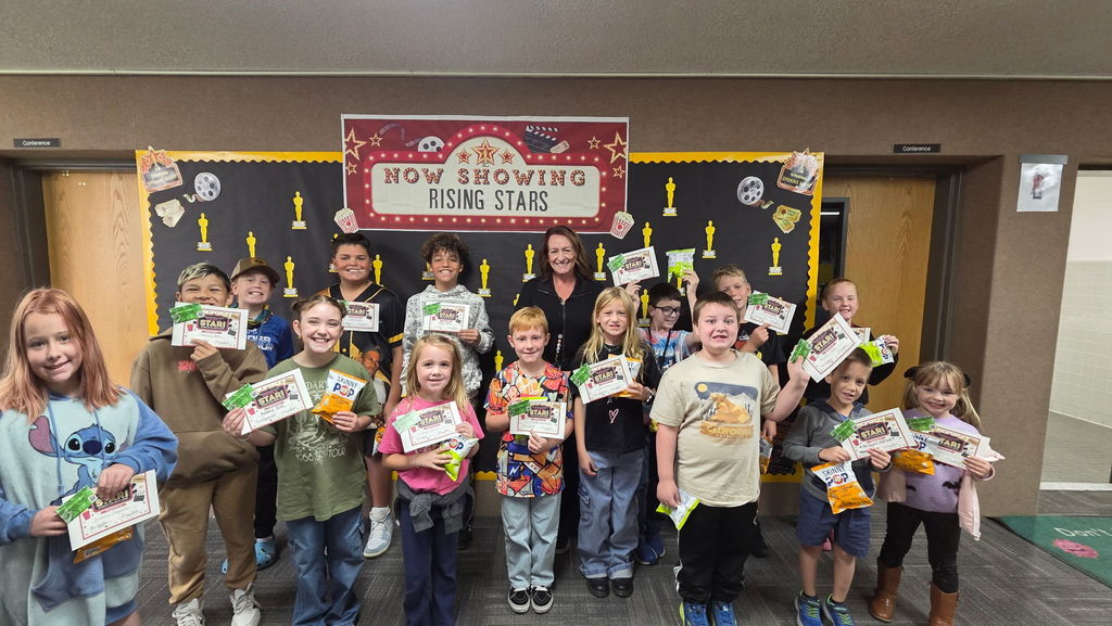 Students posing with their certificate and free movie ticket for achieving the Student of the Month in their class!!  