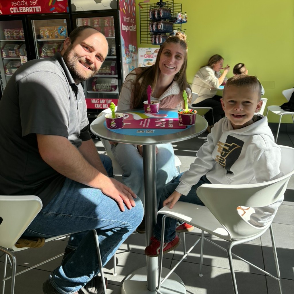 a boy and his parents eating Menchies