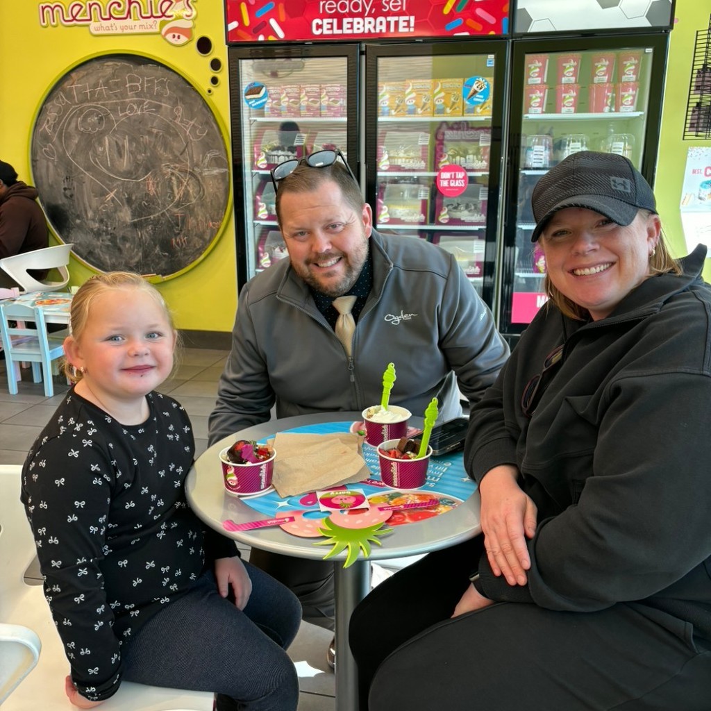A girl and her parents eating Menchies