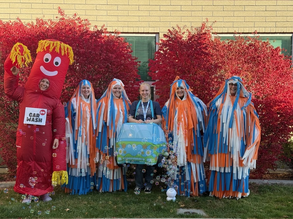 5th Grade Team dressed up like a Car wash with a scooby doo van and the rollers, and the wiggly arm  man