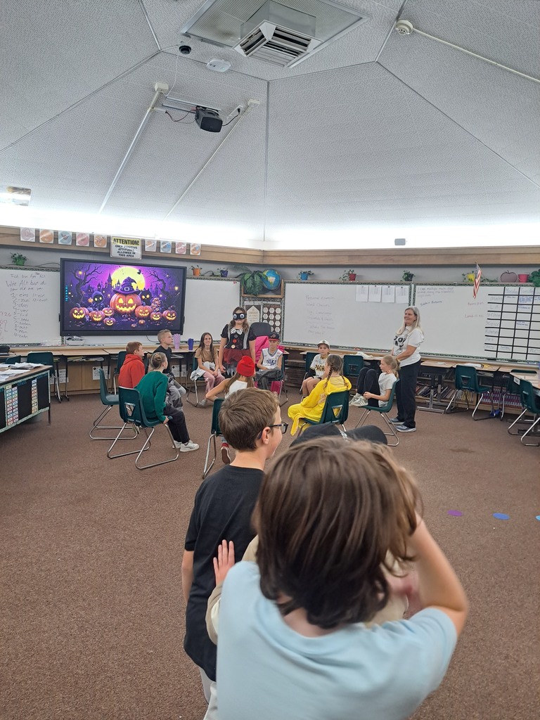 A collection of photos showing elementary students in various Halloween costumes participating in classroom parties. The images include students doing art projects, making snacks, drinking punch, and playing games with their teachers and parent volunteers.