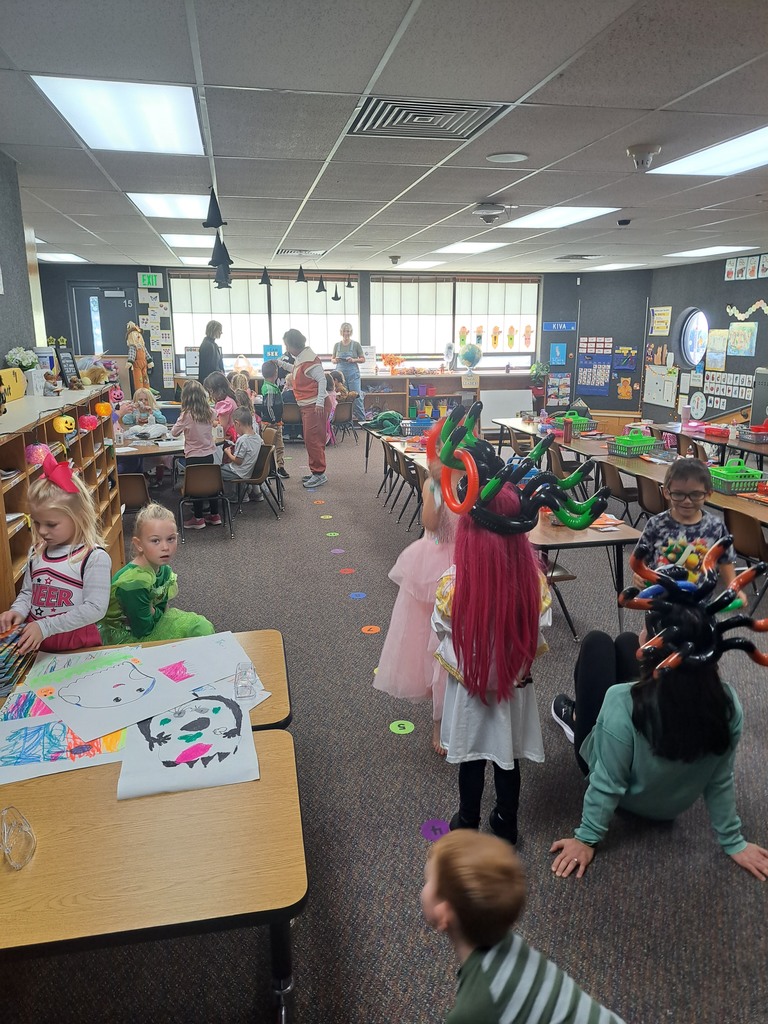 A collection of photos showing elementary students in various Halloween costumes participating in classroom parties. The images include students doing art projects, making snacks, drinking punch, and playing games with their teachers and parent volunteers.