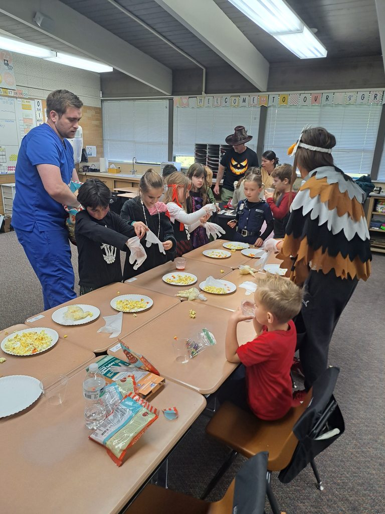 A collection of photos showing elementary students in various Halloween costumes participating in classroom parties. The images include students doing art projects, making snacks, drinking punch, and playing games with their teachers and parent volunteers.