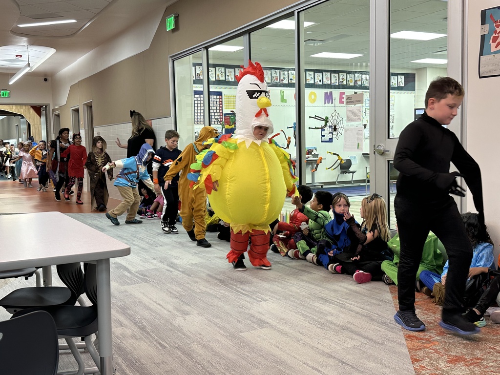 students walking in the halloween parade in their costumes