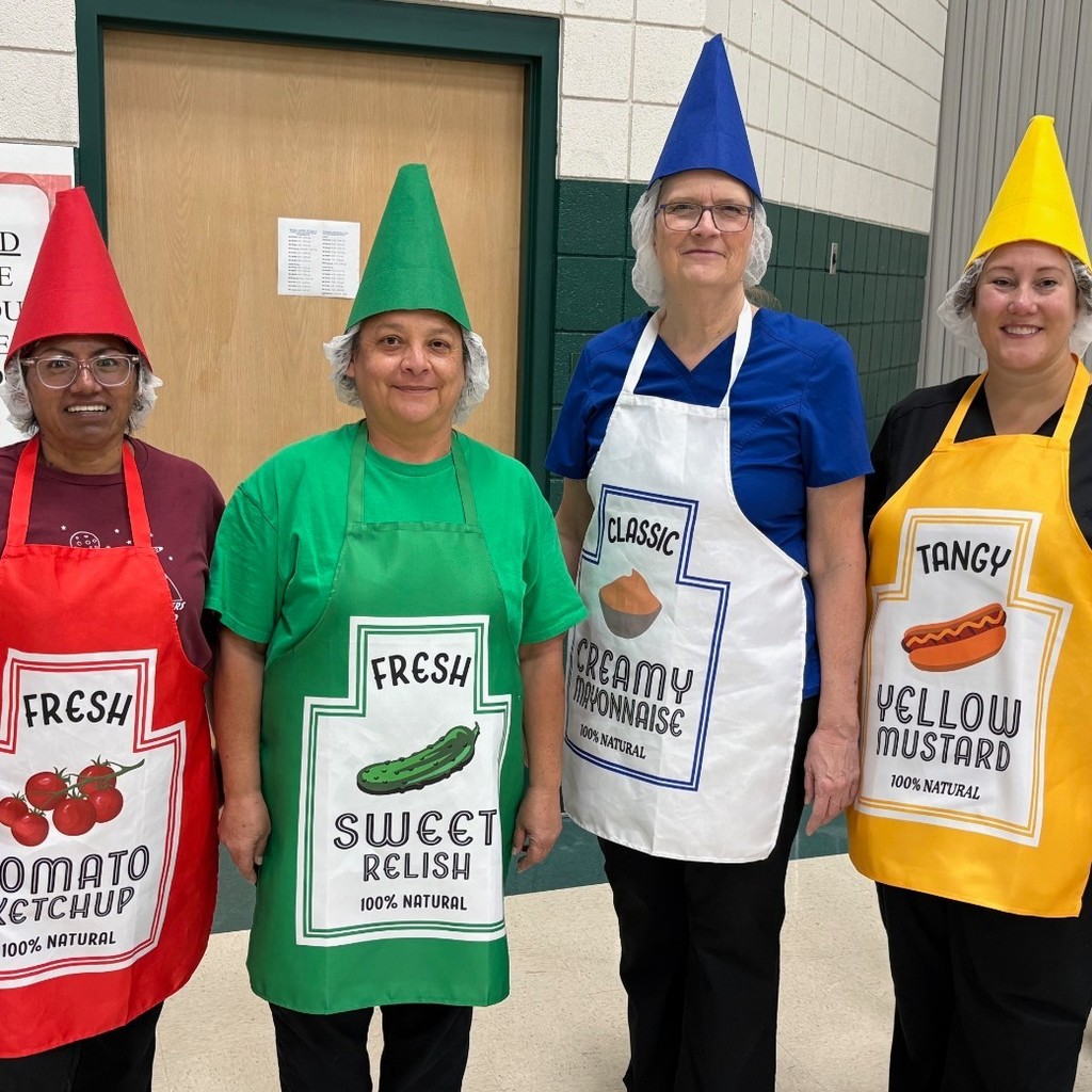 Lunch ladies dressed as ketchup, mustard, Mayo, and relush