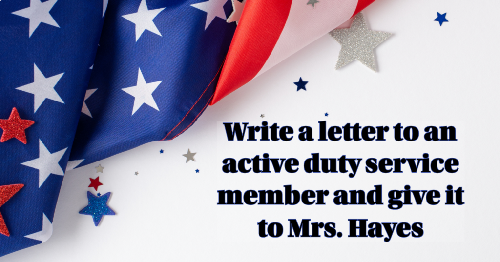 A close-up corner view of a folded American flag with red, white, and blue star-shaped confetti scattered across a white background. Overlay text reads: "Write a letter to an active duty service member and give it to Mrs. Hayes"
