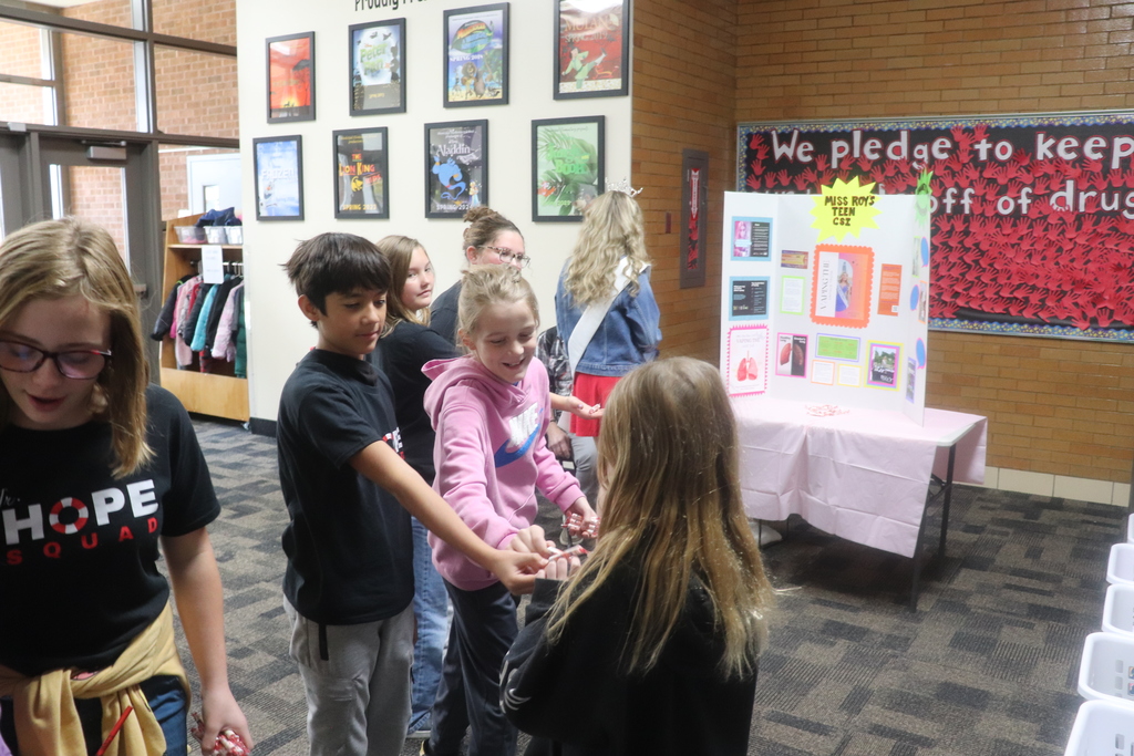 students posing for red ribbon week photos , pledging to be drug free