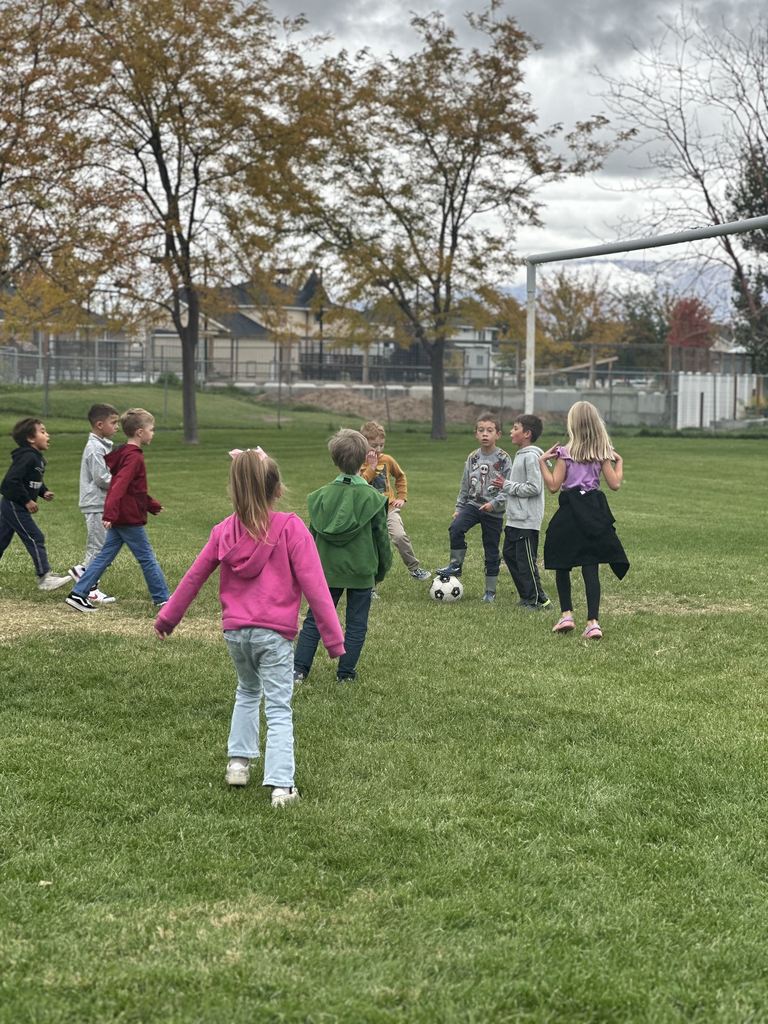 Mrs. Taurone class earing their reward playing soccer and eating donuts.