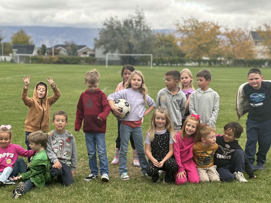 Mrs. Taurone class earing their reward playing soccer and eating donuts.