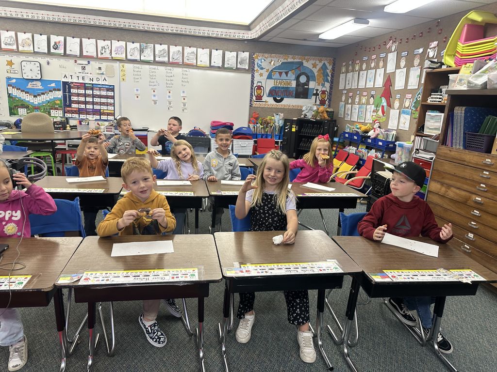 Mrs. Taurone class earing their reward playing soccer and eating donuts.