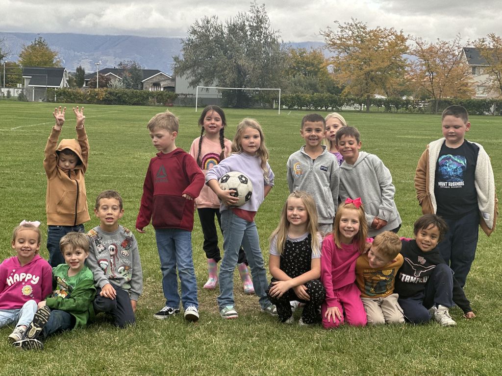 Mrs. Taurone class earing their reward playing soccer and eating donuts.