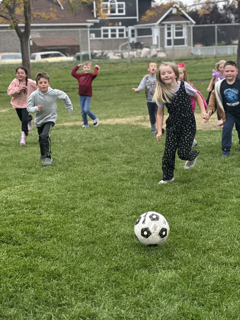 Mrs. Taurone class earing their reward playing soccer and eating donuts.