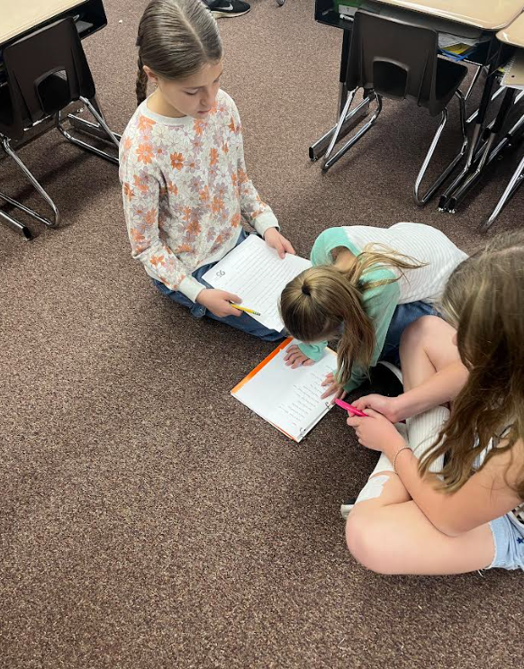 5th grade buddies helping our first graders track their reading and build fluency 