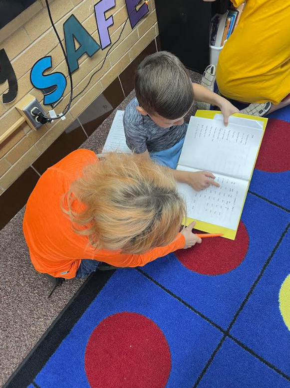 5th grade buddies helping our first graders track their reading and build fluency 