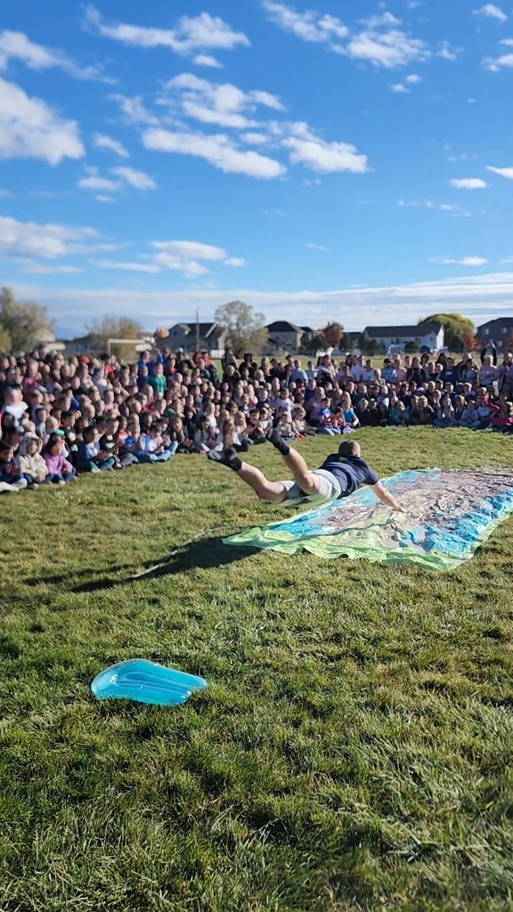 Mr. Talbot flying onto the pudding Slip N Slide in a very baseball like face first slide