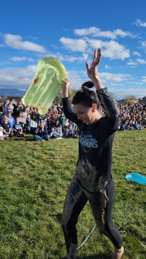Mrs. Watkins celebrating after flying down the pudding slip in slide