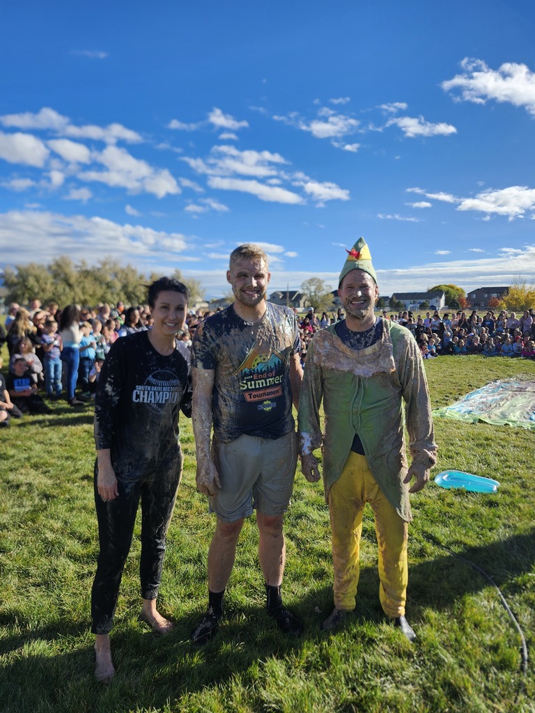 Mrs. Watkins, Mr. Talbot, and Mr. Lott posing after their first slide on the Pudding Slip N Slide