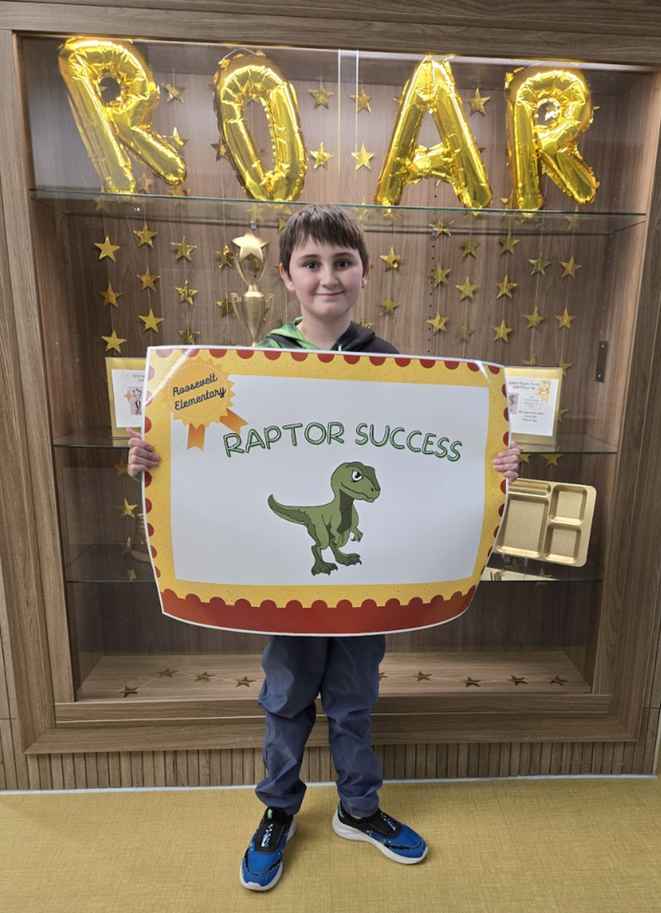 student holding a certificate for the awards they received