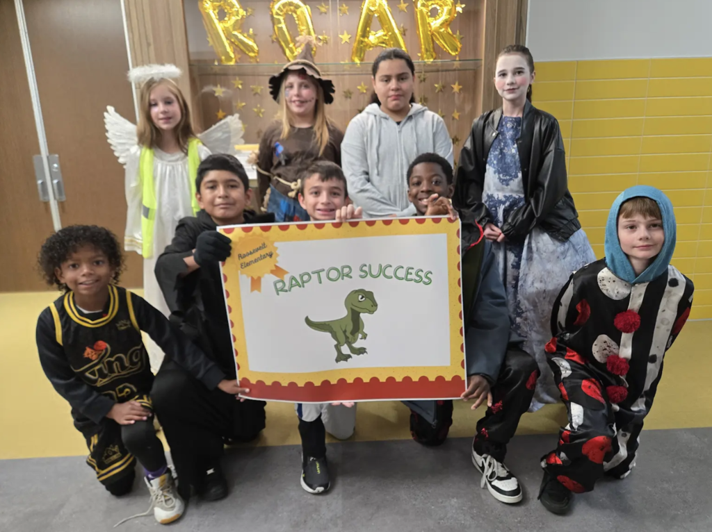 students holding a certificate for the awards they received
