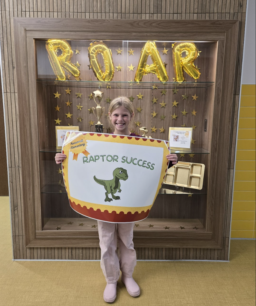 student holding a certificate for the awards they received