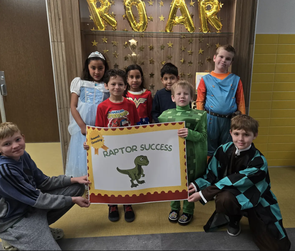 students holding a certificate for the awards they received