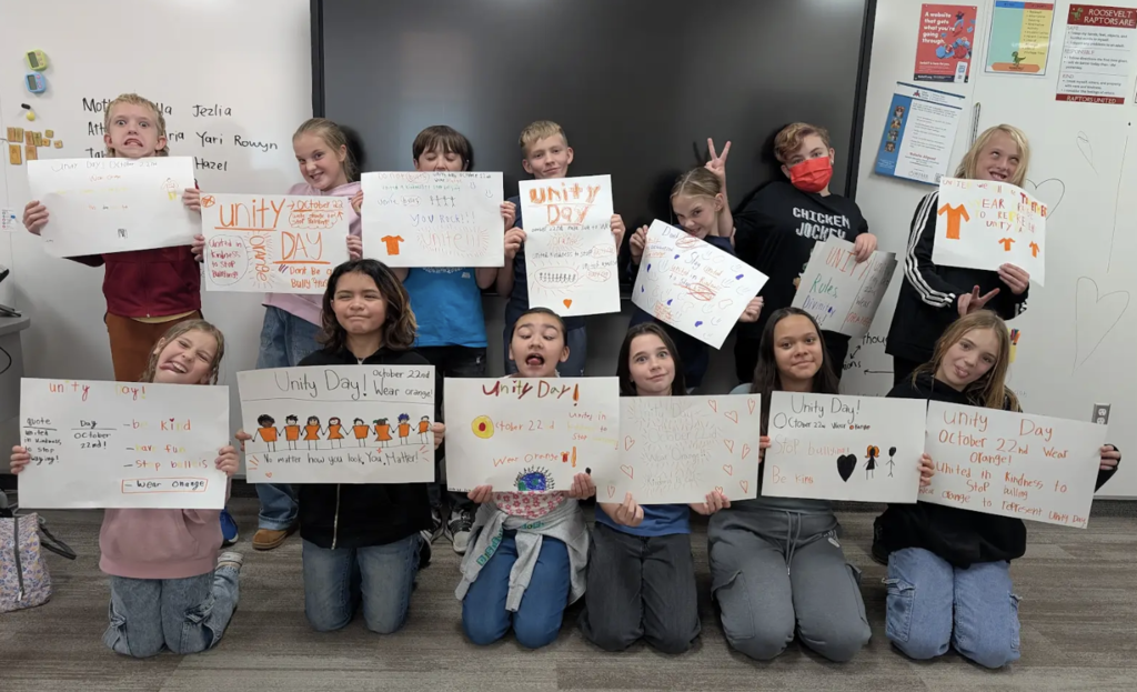 kids being silly with the posters that they created for hope squad