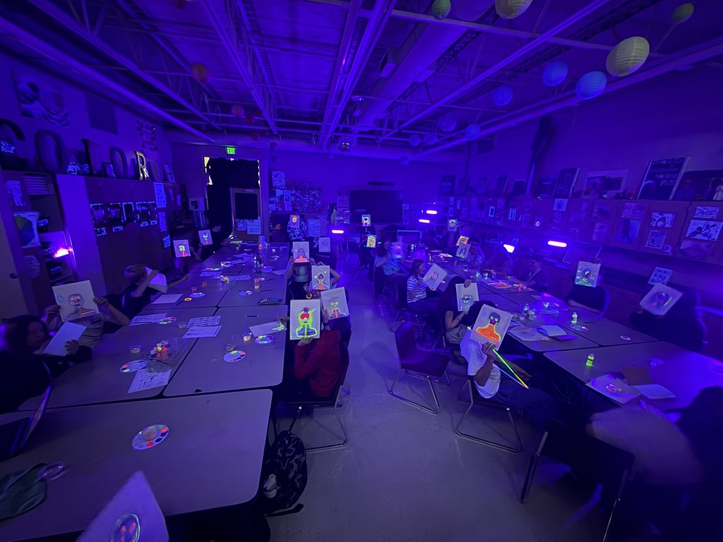 Blacklight Painting- All 2D Art students spent the week in painting in the dark! Art 1 students learned about Dia de los Muertos last week and painting skeleton portraits using colors and symbols that represent themselves and their ancestors. Art 2 students used different colors to draw each other in poses and gestures focusing on value with the different colors. Finally, Art 3 students practiced making their first mural by making an ofrenda that students could hang their completed skeletons on. 