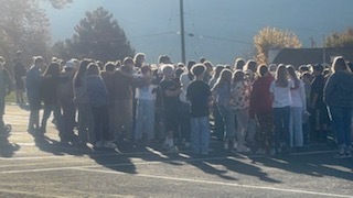 Bates Elementary 5th and 6th graders singing patriotic songs while looking at the flag flying in Cold Water Canyon.