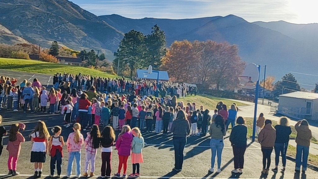 Bates Elementary singing patriotic songs while looking at the flag flying in Cold Water Canyon.  