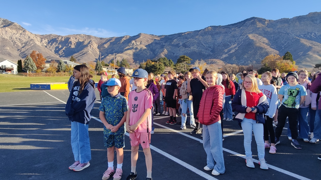 The students of Bates Elementary looking up to the flag in Cold Water Canyon while singing patriotic songs. 