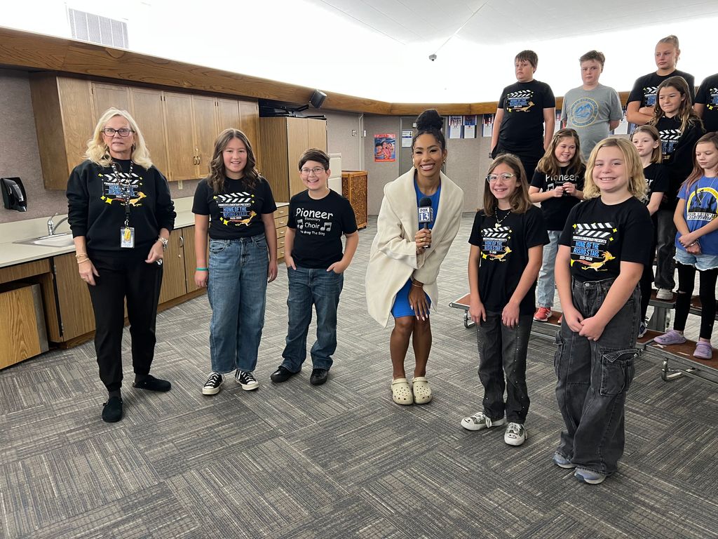 Teacher and Students posing with Fox News Reporter