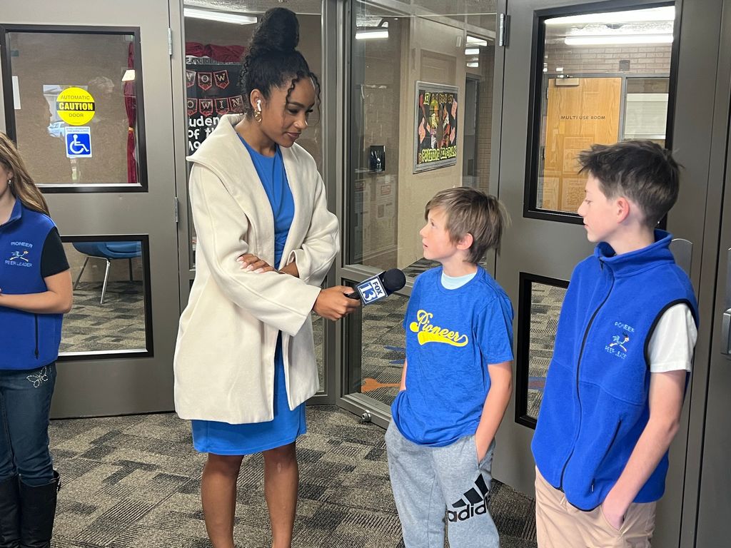 Students being interviewed by reporter