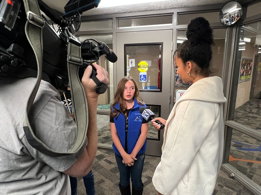 Student being interviewed by reporter