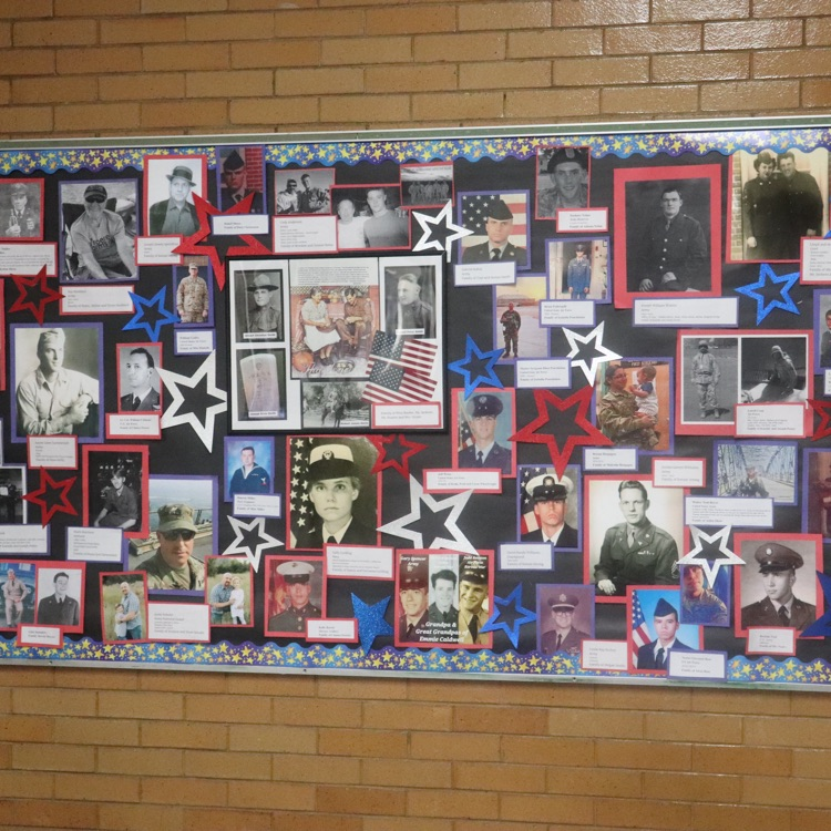 Veterans Day honor wall full of pictures of veterans 