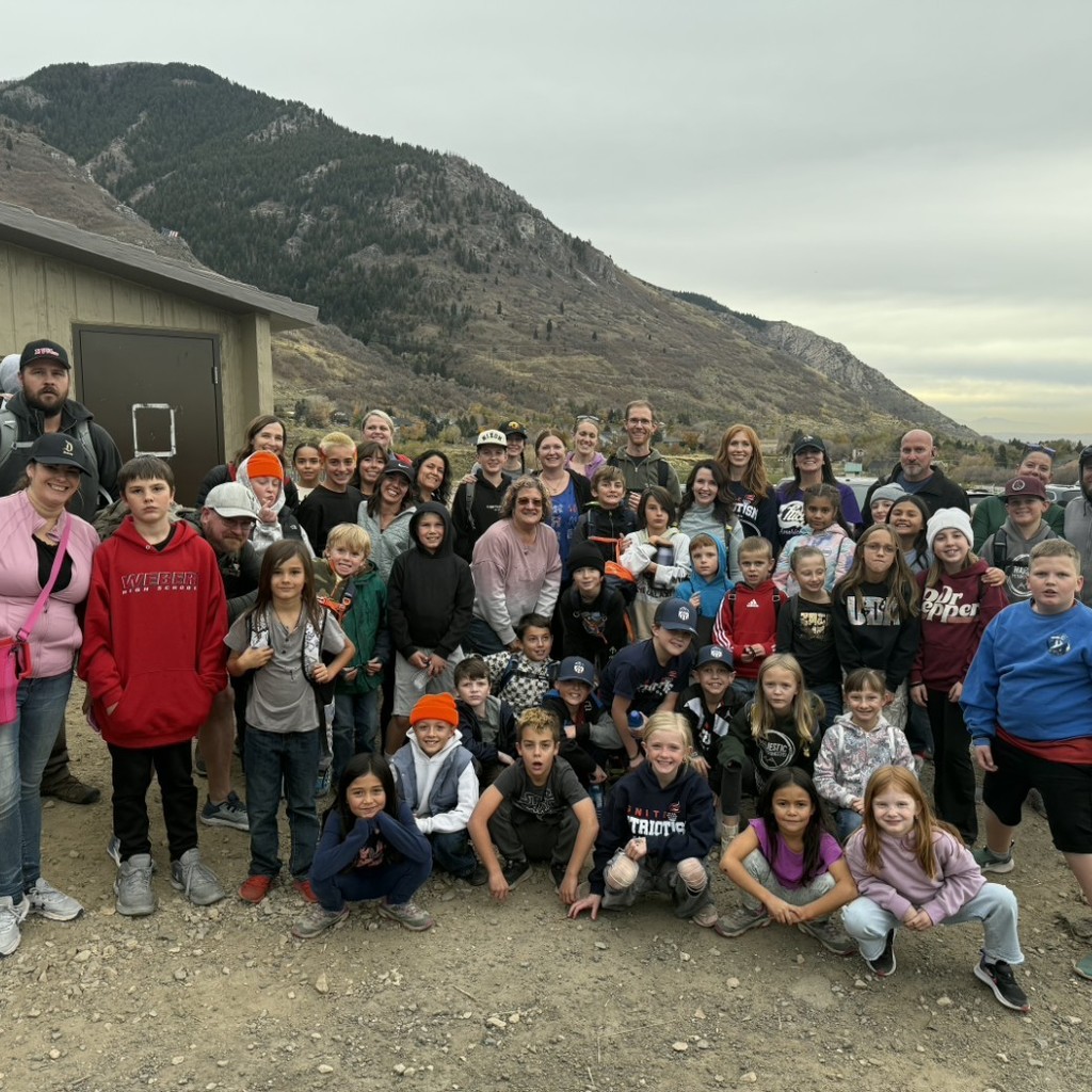 Majestic students, families, and staff in front of a mountain