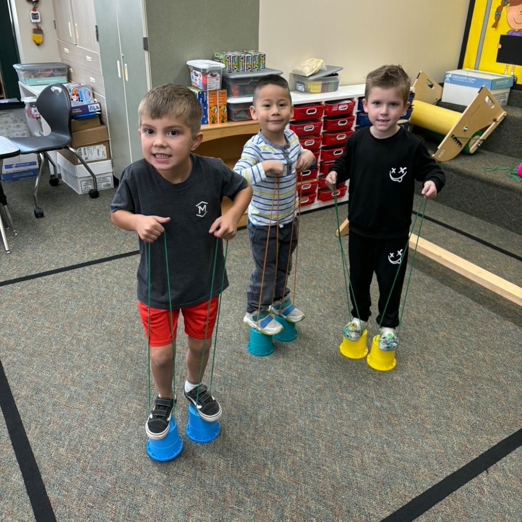 Boys walking on walking cups