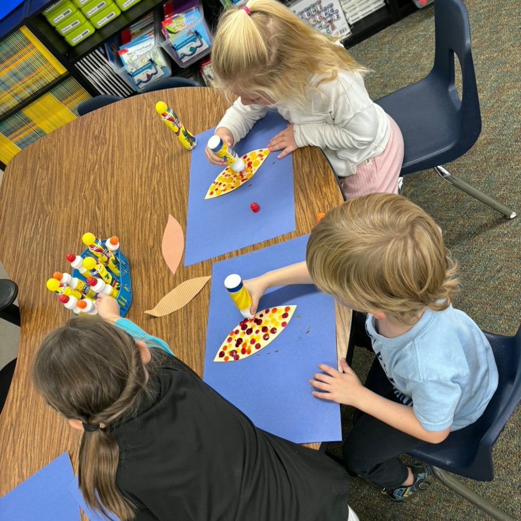 Kids gluing a picture