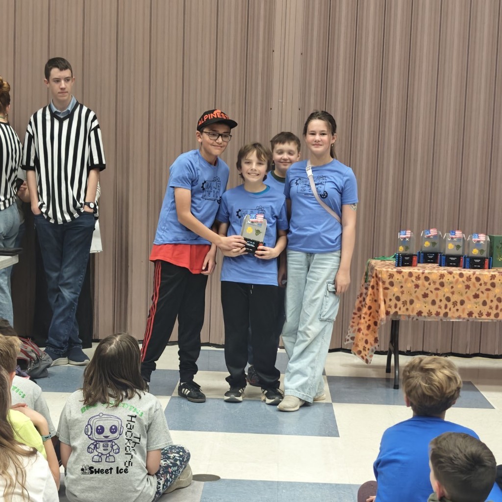 students receiving award at robotics competition.