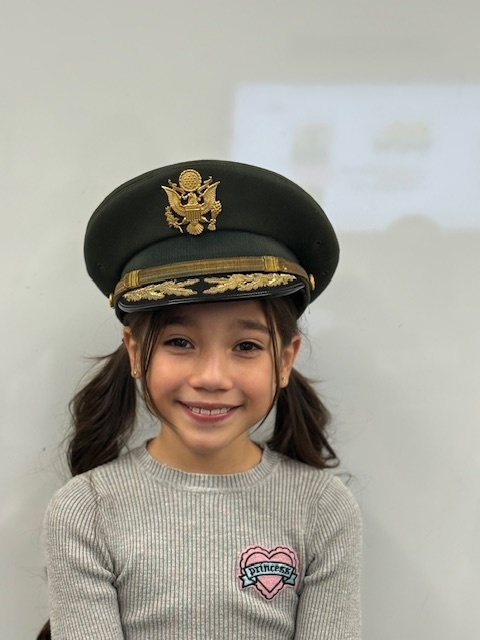 A student in a colonel hat