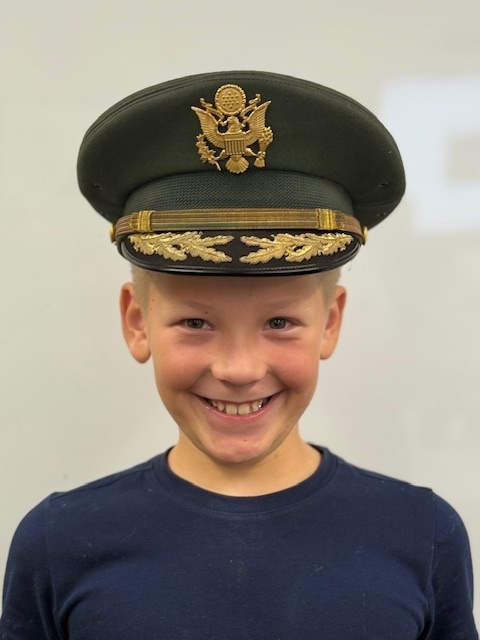 A student in a colonel hat