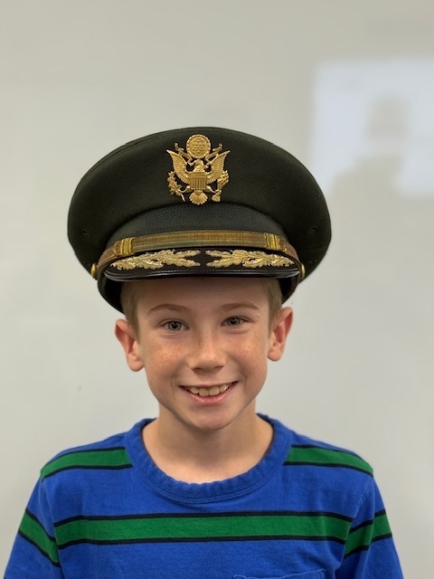 A student in a colonel hat