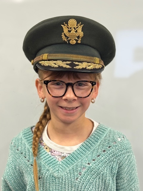 A student in a colonel hat