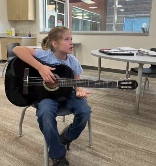 student playing the guitar