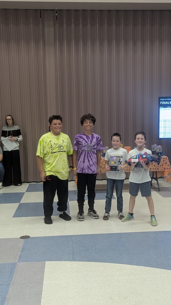 Robotics Members holding award and robot after competition