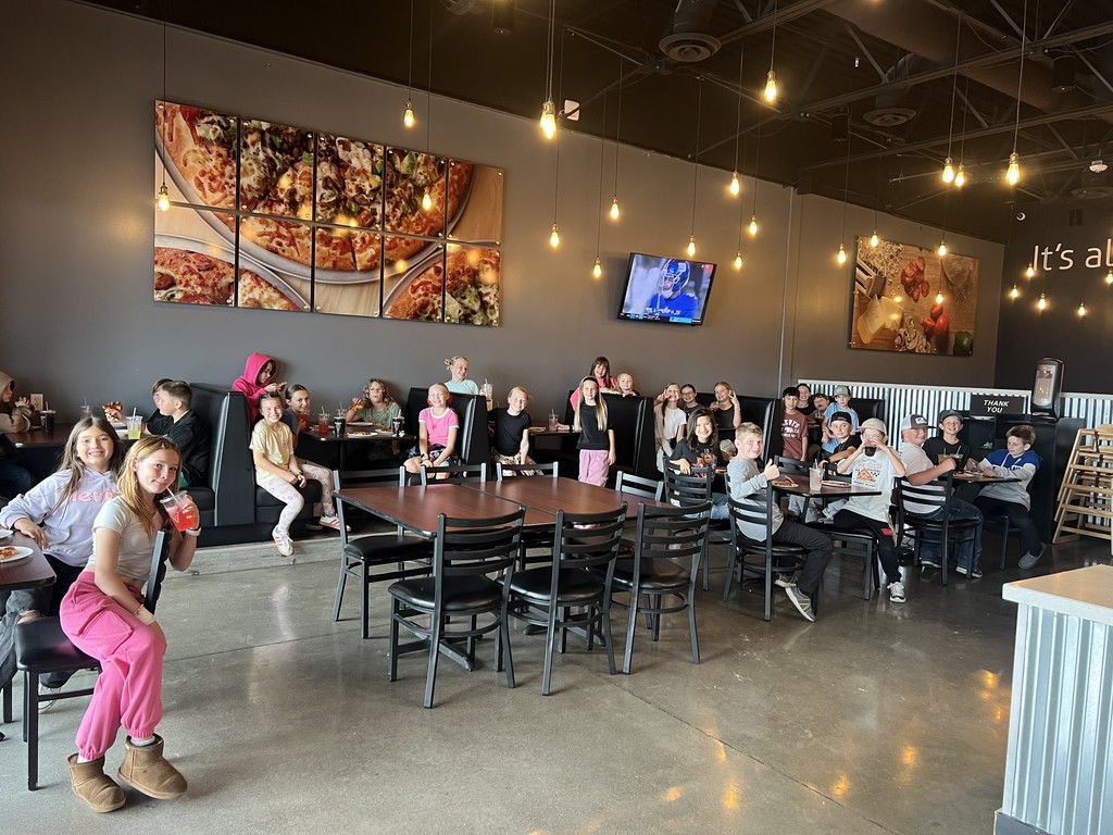 Group of students eating pizza at Westside Pizza