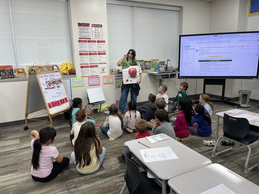 a first grade class listening to a demonstration and explanation about seeds.