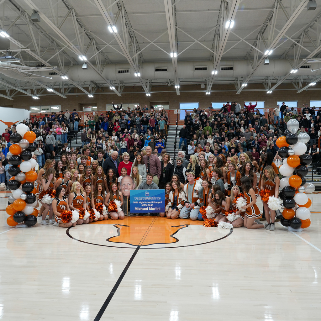 Mr. Martini in front of student assembly