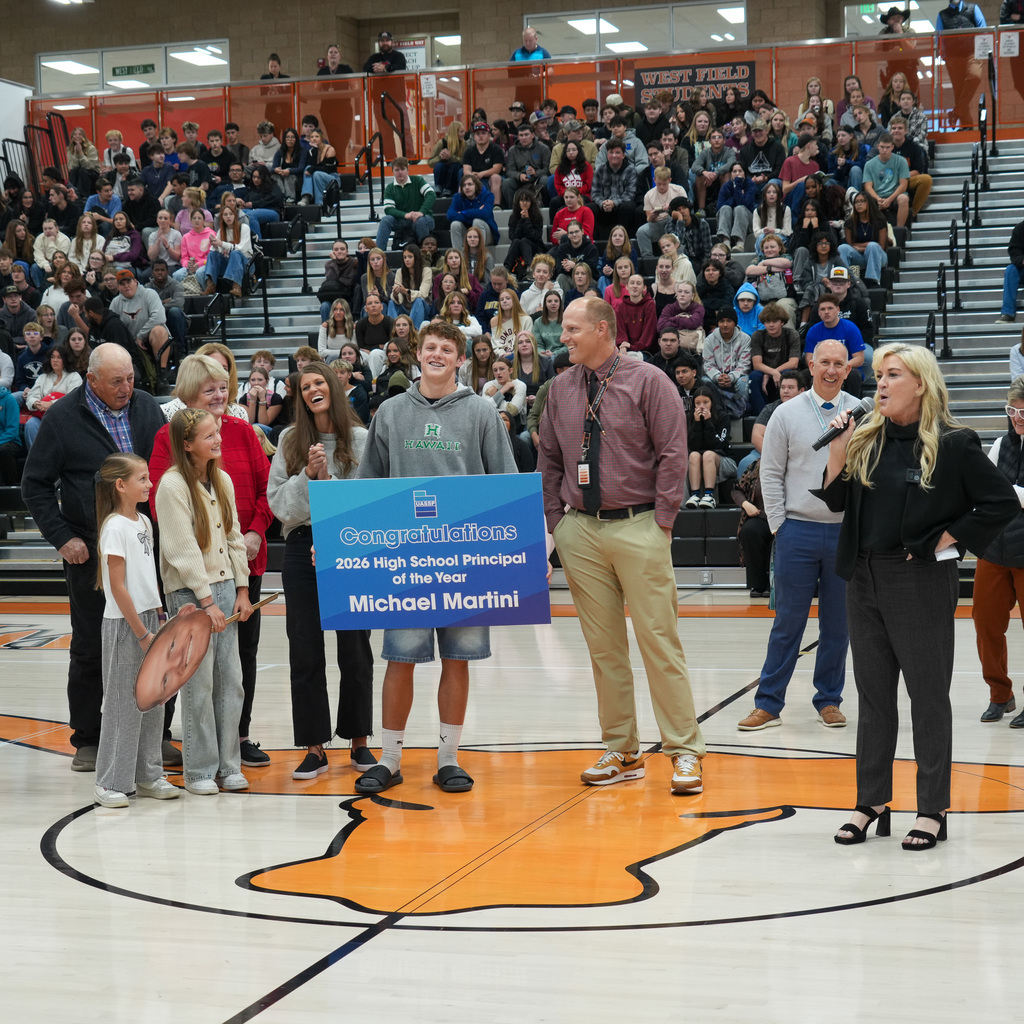 Mr. Martini in front of student assembly
