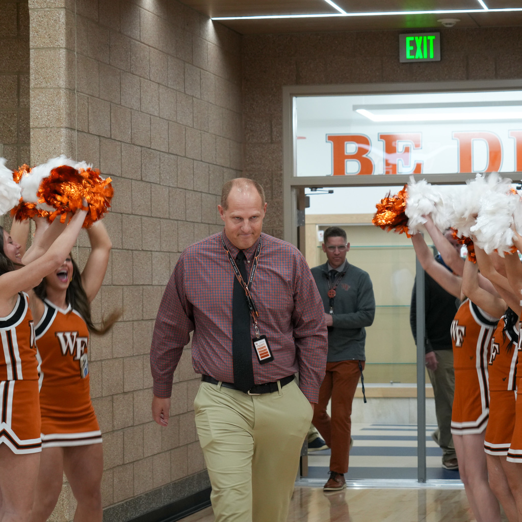 Mr. Martini walking in to student assembly